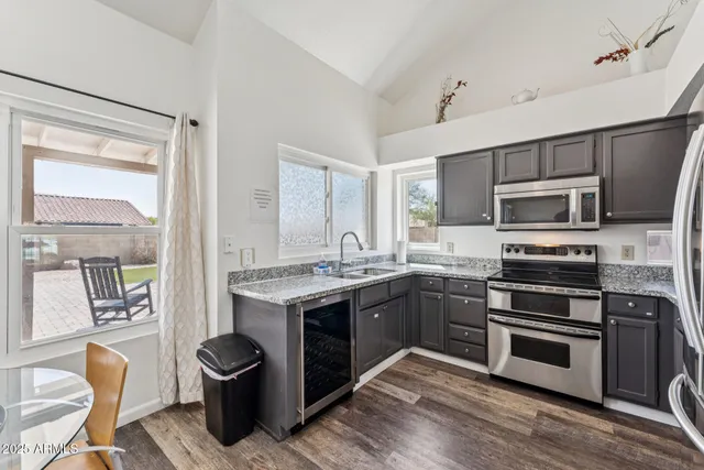 a kitchen with a sink stove and microwave
