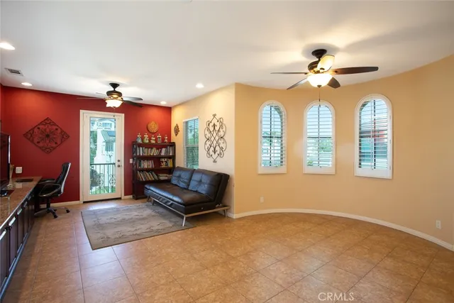 a bedroom with a bed wooden floor and window