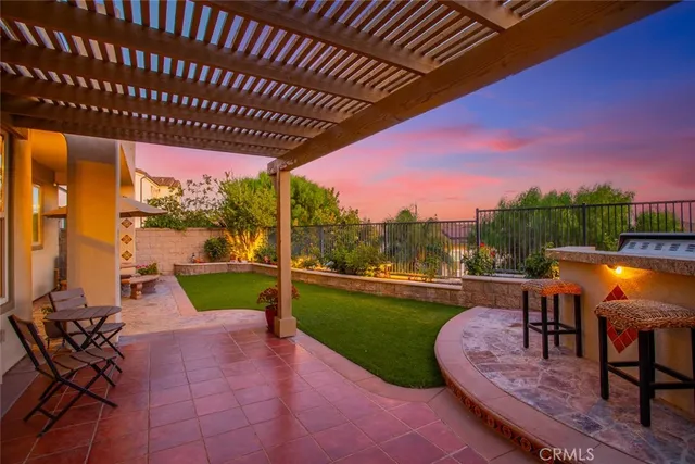 a view of a patio with table and chairs and potted plants