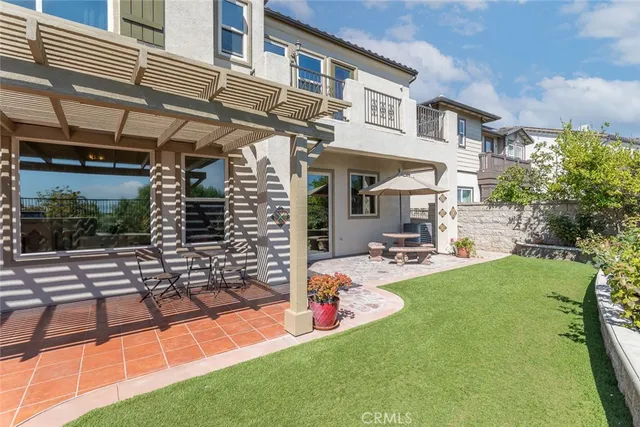 an aerial view of a city with lots of residential buildings ocean and mountain view in back