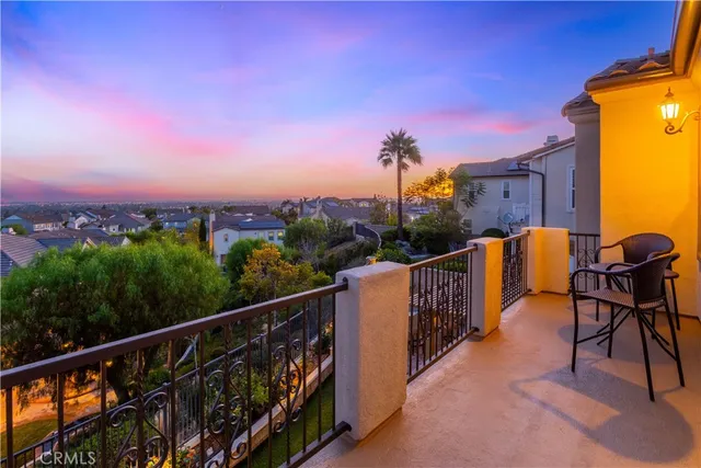 a balcony with wooden floor and city view