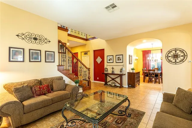 a living room with furniture a rug and a wall painting
