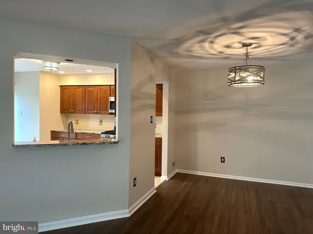 a view of a livingroom with wooden floor and a window