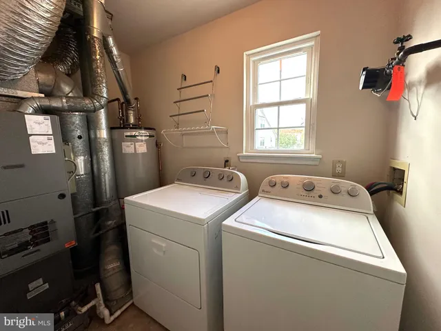 a view of storage and utility room with washer and dryer