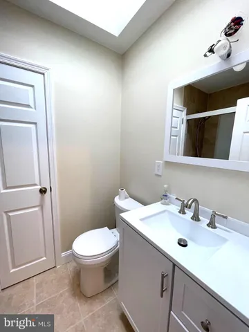 a bathroom with a sink toilet and mirror