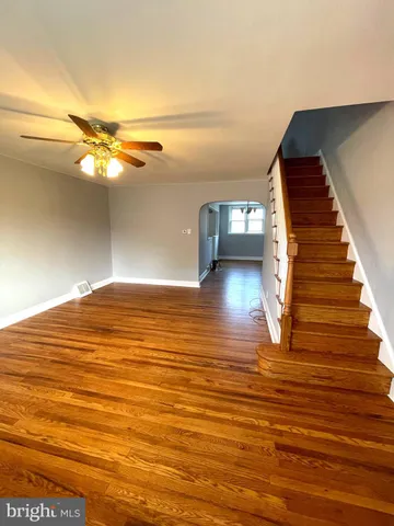 a view of empty room with wooden floor