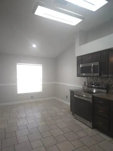 a kitchen with stainless steel appliances a sink stove and microwave