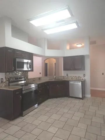 a large kitchen with a sink and cabinets