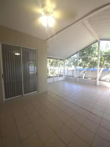 an empty room with windows and outdoor view