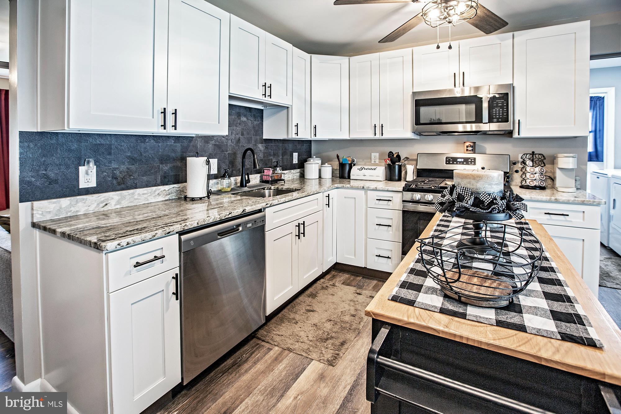 10 Lafayette Road Pennsville, NJ 08070 - Photo 5 of 22 a kitchen with stainless steel appliances a sink a stove and cabinets