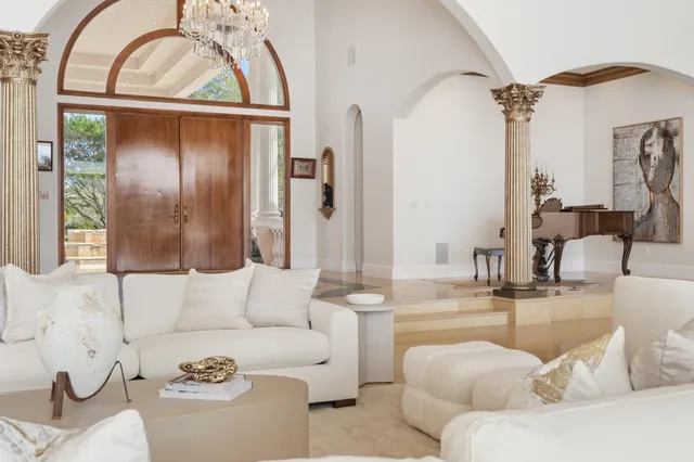 a bedroom with a bed and large windows