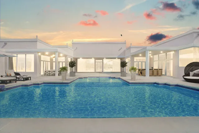 a backyard of a house with table and chairs