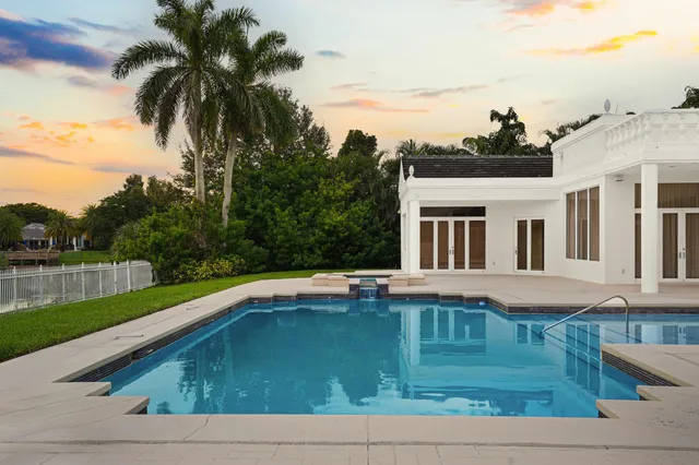 a kitchen with granite countertop a sink and white cabinets