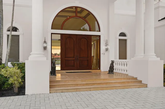a view of a dining room and livingroom with furniture wooden floor a chandelier