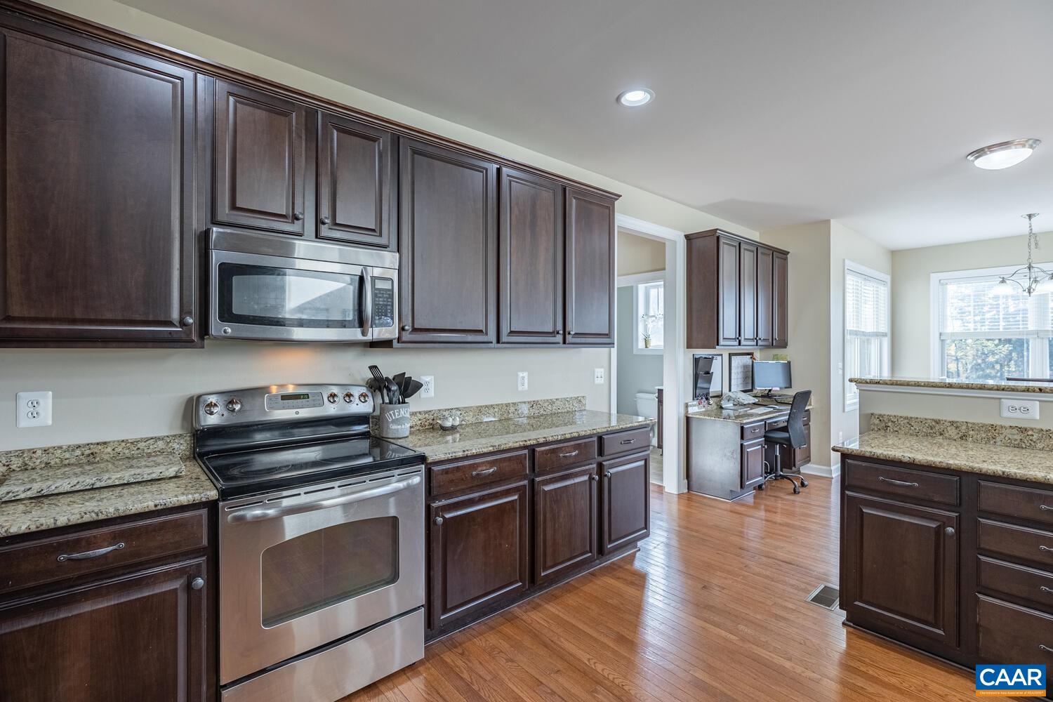 97 Wexford Ridge Road Ruckersville, VA 22968 - Photo 14 of 70 a kitchen with stainless steel appliances granite countertop wooden cabinets and a stove top oven