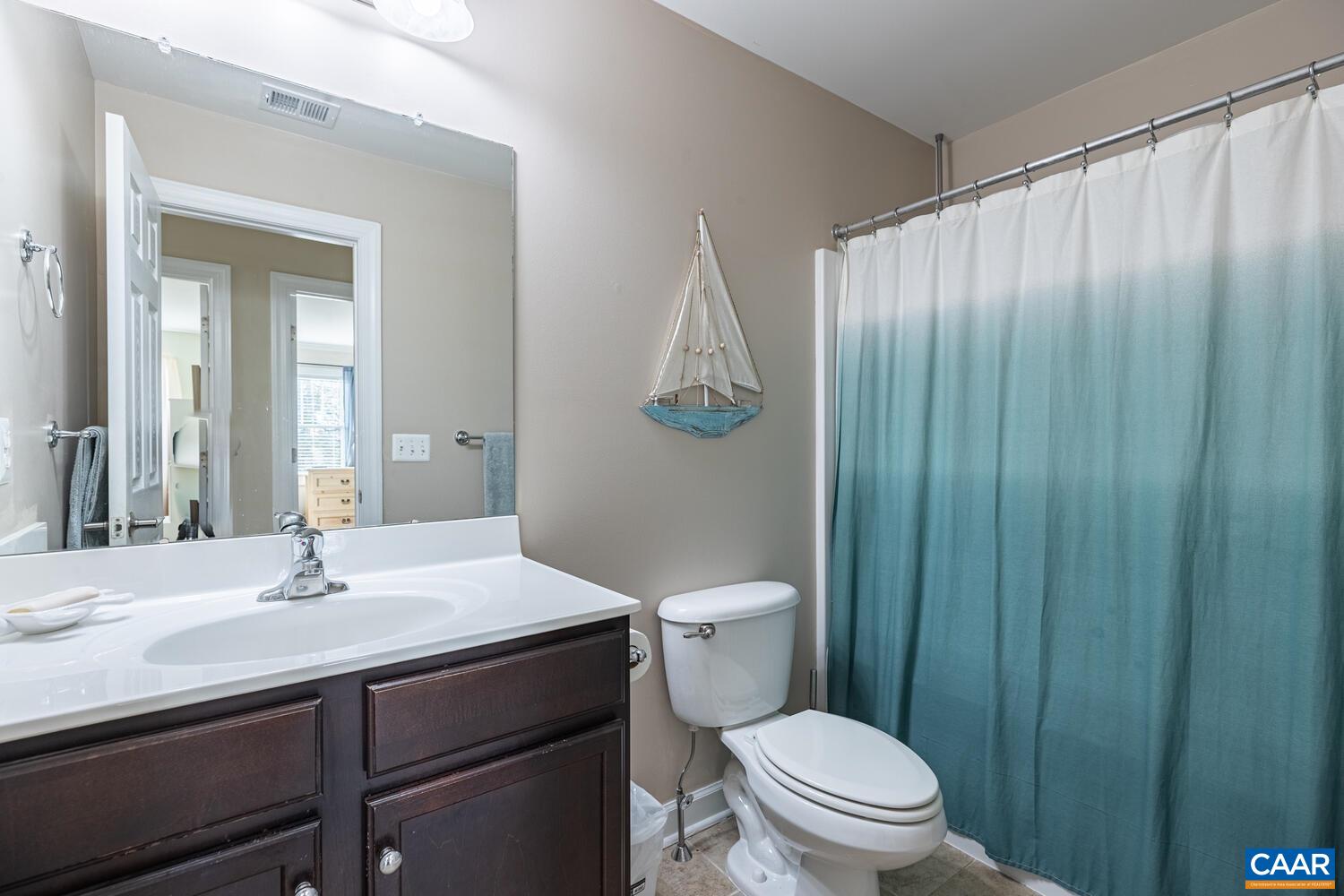 97 Wexford Ridge Road Ruckersville, VA 22968 - Photo 32 of 70 a bathroom with a sink a toilet and shower curtain