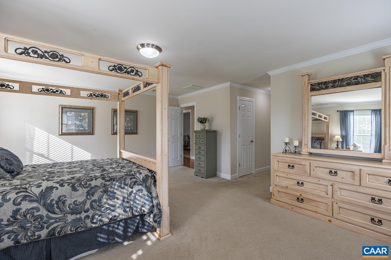 97 Wexford Ridge Road Ruckersville, VA 22968 - Photo 35 of 70 a bedroom with a large bed and closet with mirror