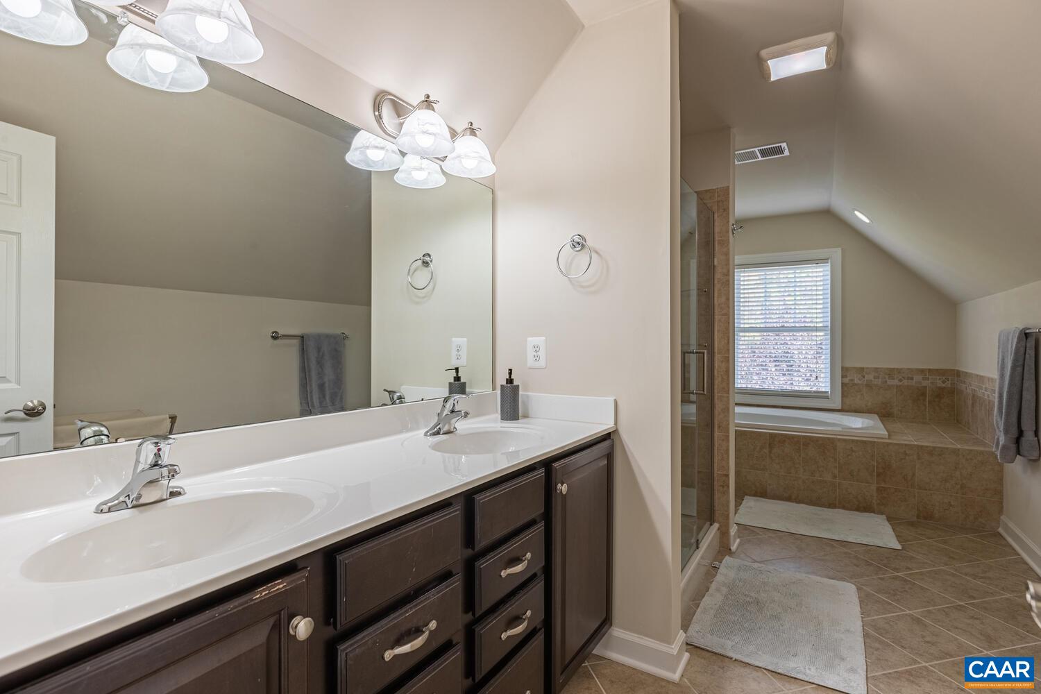 97 Wexford Ridge Road Ruckersville, VA 22968 - Photo 36 of 70 a bathroom with a sink a large mirror and a shower