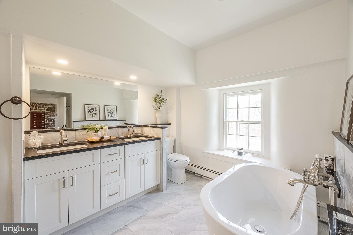 1640 Sheeder Mill Spring City, PA 19475 - Photo 33 of 63 a large bathroom with a double vanity sink a mirror and a bathtub