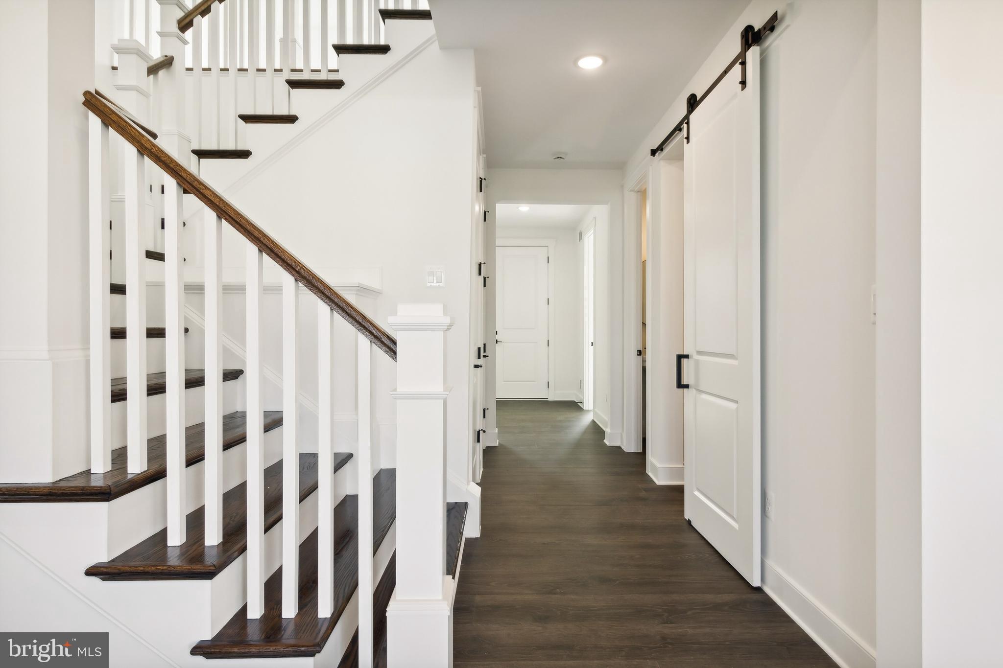 36435 Maple Ridge Lane Georgetown, DE 19947 - Photo 2 of 38 a view of a hallway with wooden floor and staircase