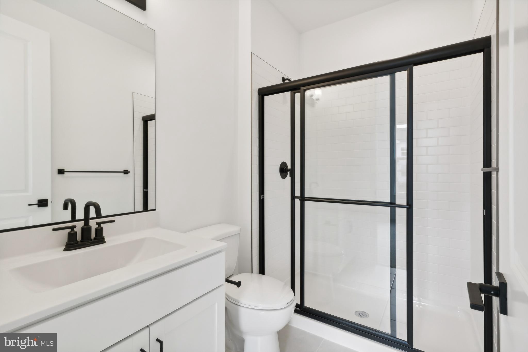 36435 Maple Ridge Lane Georgetown, DE 19947 - Photo 21 of 38 a bathroom with a sink a toilet and a mirror