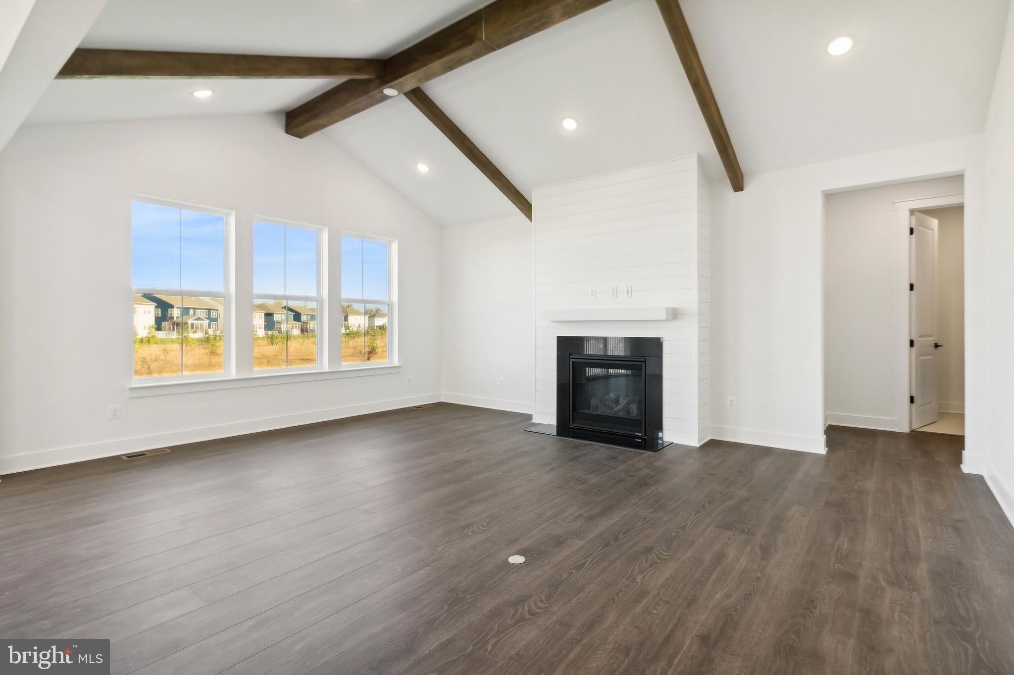 36435 Maple Ridge Lane Georgetown, DE 19947 - Photo 9 of 38 a view of an empty room with a window and fireplace
