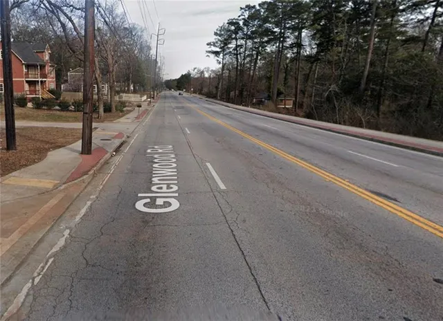 a view of a street with houses on both side