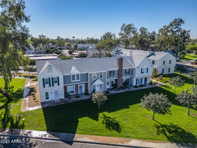 an aerial view of residential houses with outdoor space