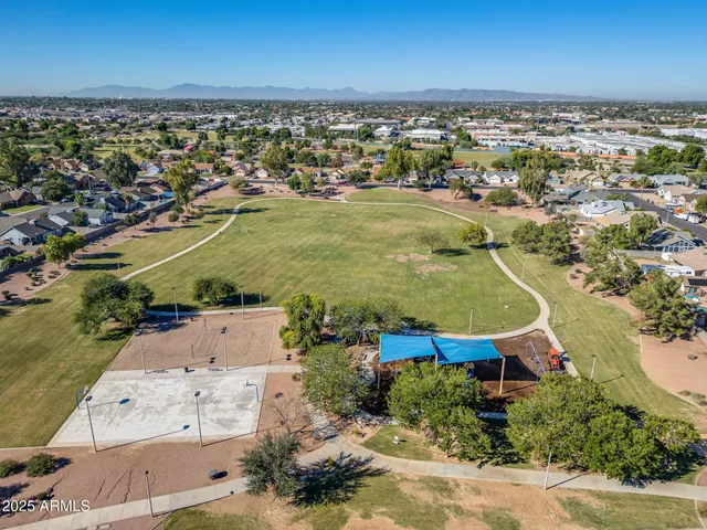 swimming pool view with a garden