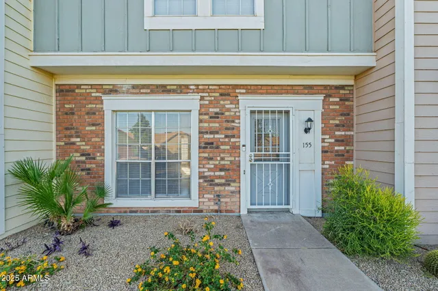 a view of front door of house with potted plant