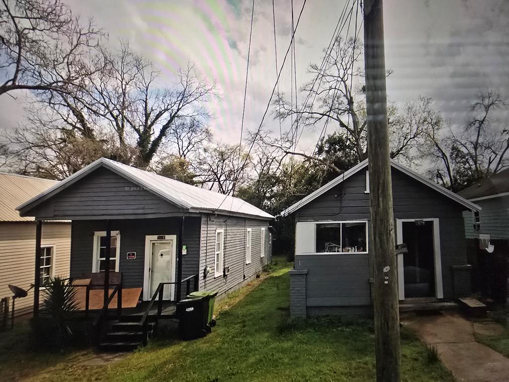 a front view of a house with yard porch and seating