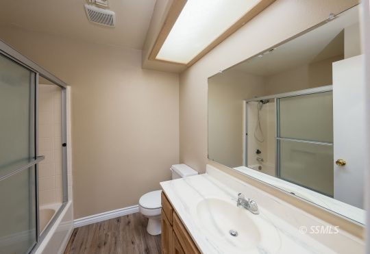 336 North Kern Street Ridgecrest, CA 93555 - Photo 11 of 35 a bathroom with a sink and mirror with toilet