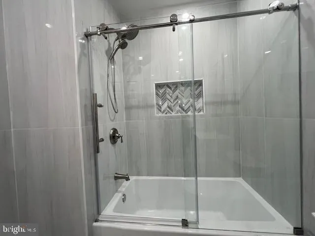 a bathroom with a shower and a glass door shower