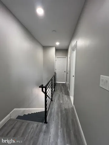 a view of hallway with wooden floor