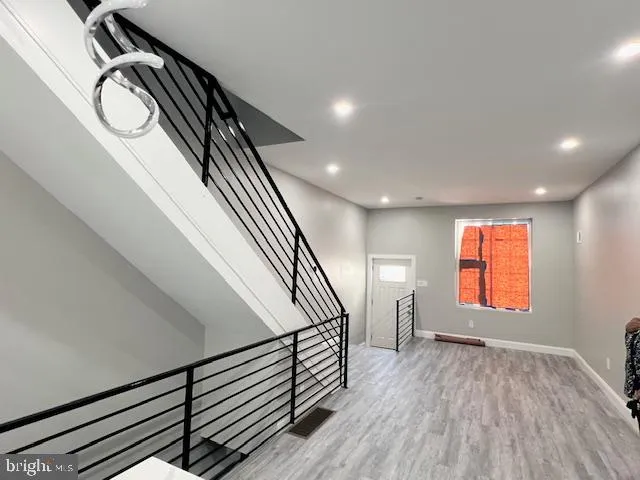 a view of entryway and hall with wooden floor