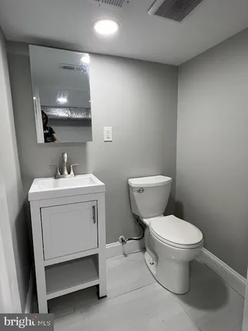 a white toilet sitting next to a bathroom sink
