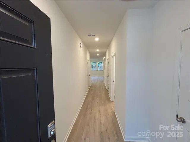 a view of hallway with wooden floor
