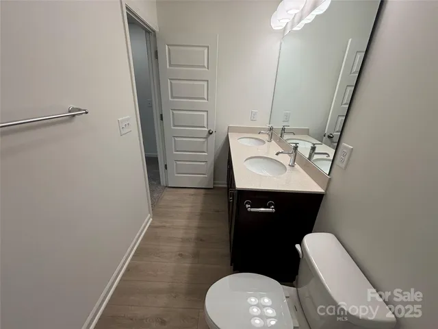 a bathroom with a sink toilet and mirror