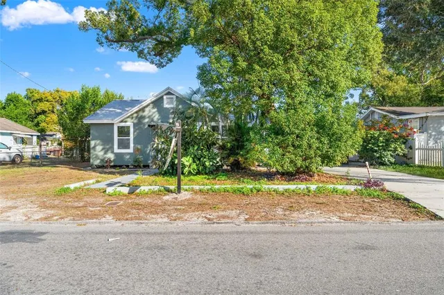 a house that has a tree in front of it