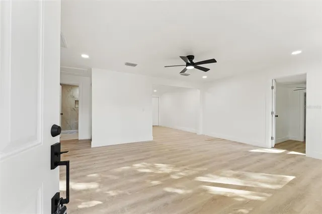 a view of a room with a ceiling fan