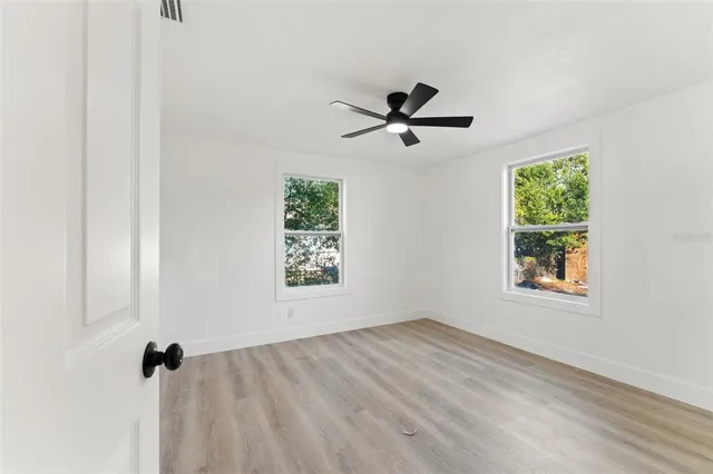 a view of empty room with ceiling fan
