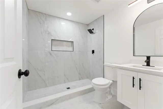 a bathroom with a toilet sink and shower