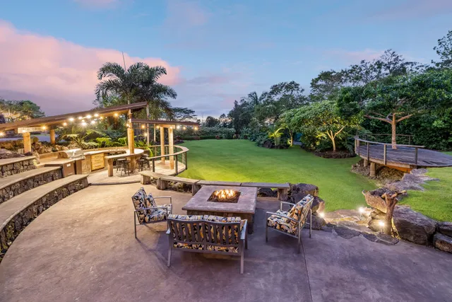 a view of a patio with table and chairs potted plants with sky view
