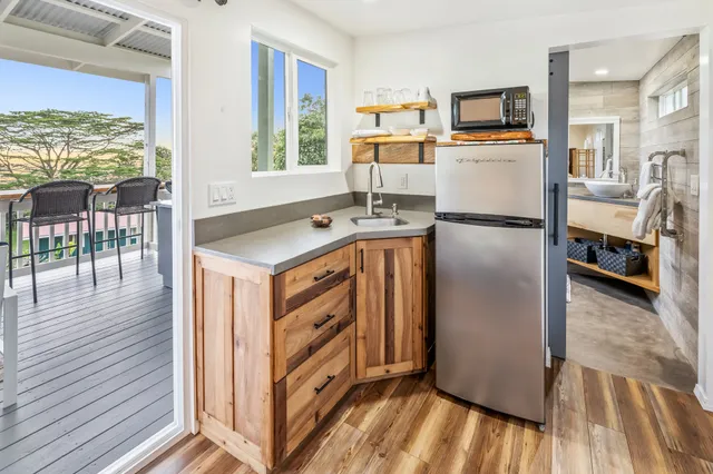 a kitchen with stainless steel appliances granite countertop a refrigerator a stove and a wooden floor