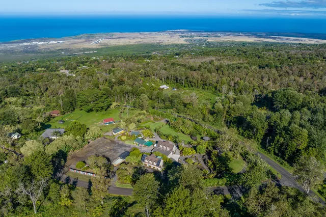 an aerial view of a houses with a yard