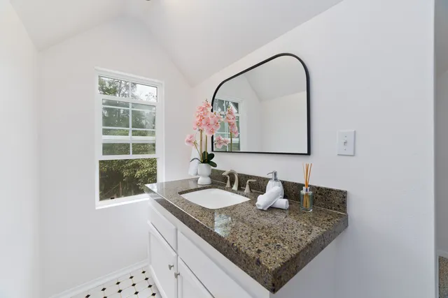 a bathroom with a sink and a mirror
