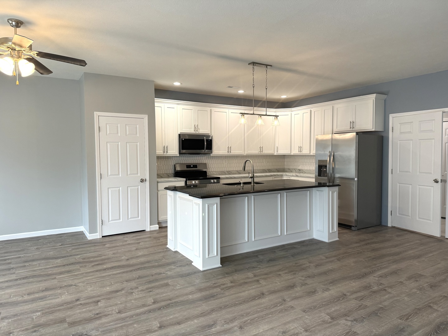 1104 Midway Court Marion, IL 62959 - Photo 2 of 13 a kitchen with a refrigerator and a stove top oven