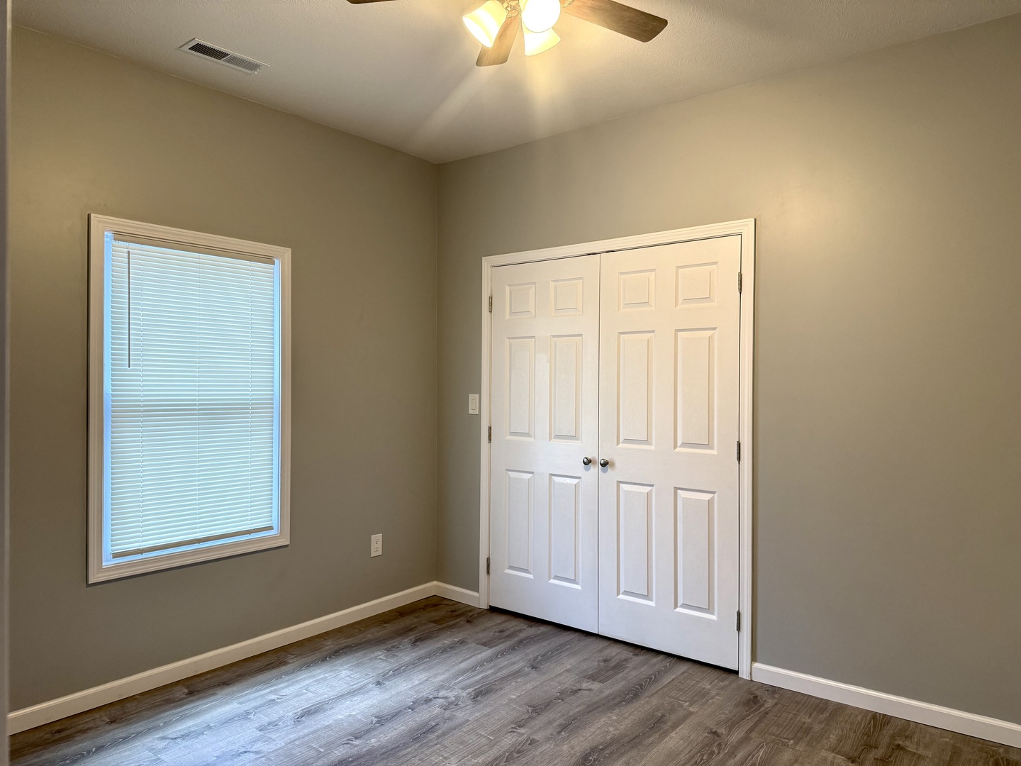 1104 Midway Court Marion, IL 62959 - Photo 7 of 13 an empty room with wooden floor chandelier fan and windows
