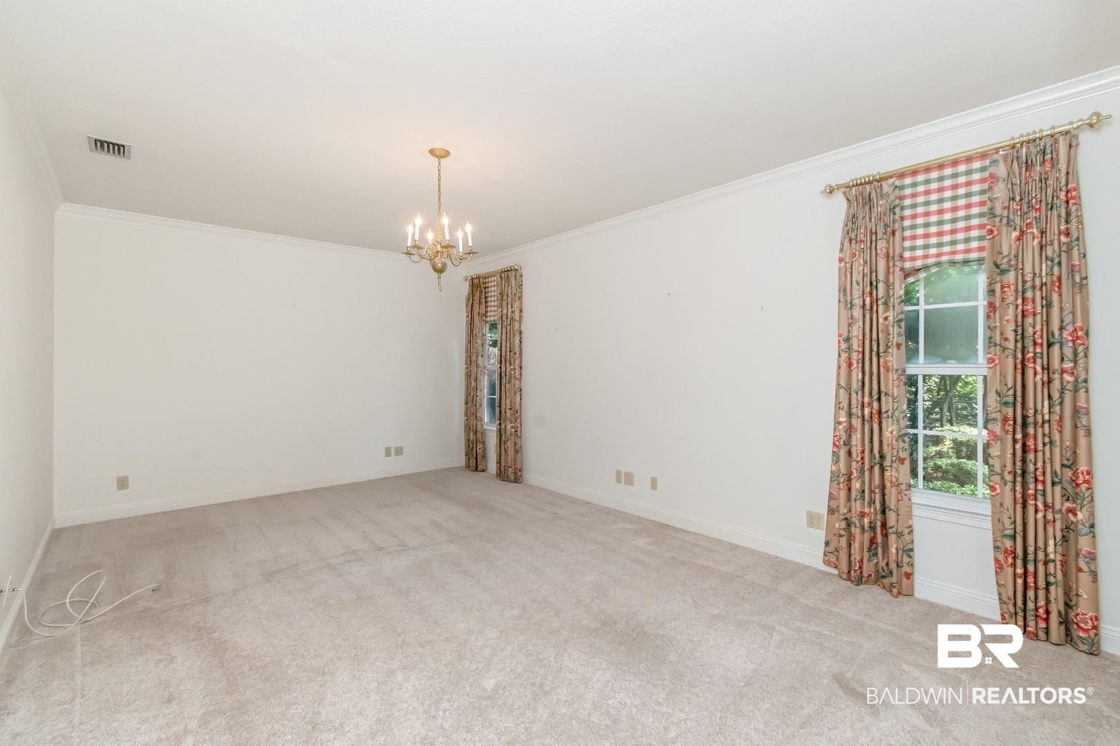 105 McHugh Lane Mobile, AL 36608 - Photo 14 of 30 Carpeted spare room featuring crown molding and a chandelier