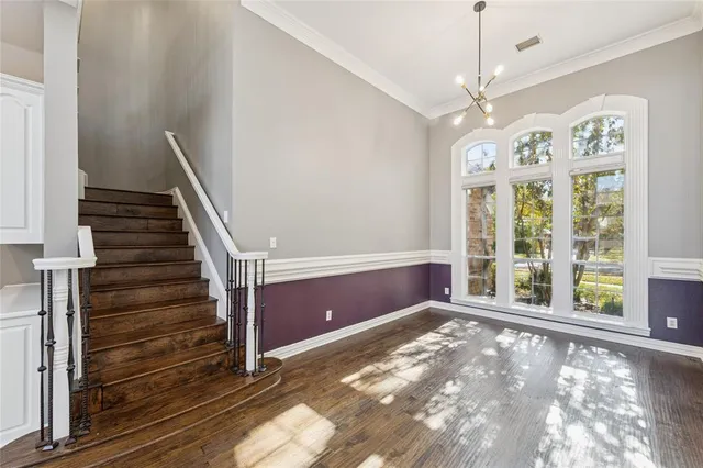 a view of a kitchen with white cabinets and a window
